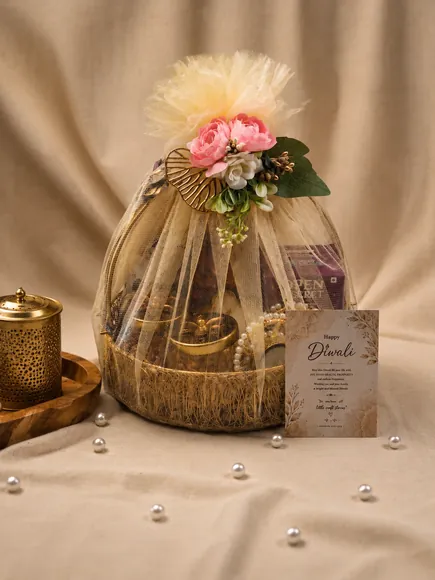 Basket hamper wrapped in a tulle dome with pink flowers