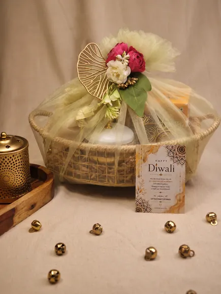Basket hamper with a golden fan, roses and a Diwali card